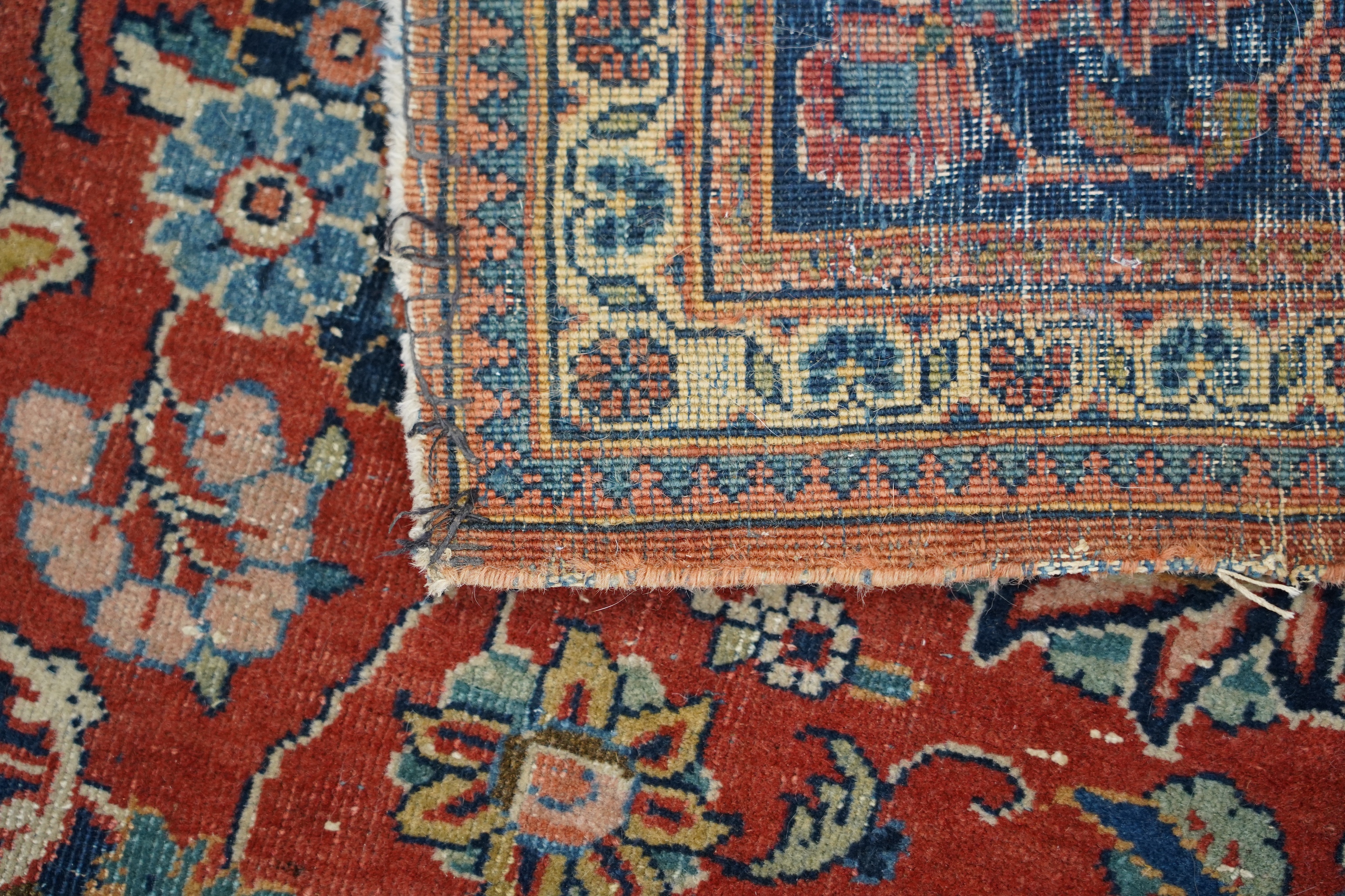 A pair of antique Tabriz brick red ground rugs, 200 x 136cm. Condition - fair